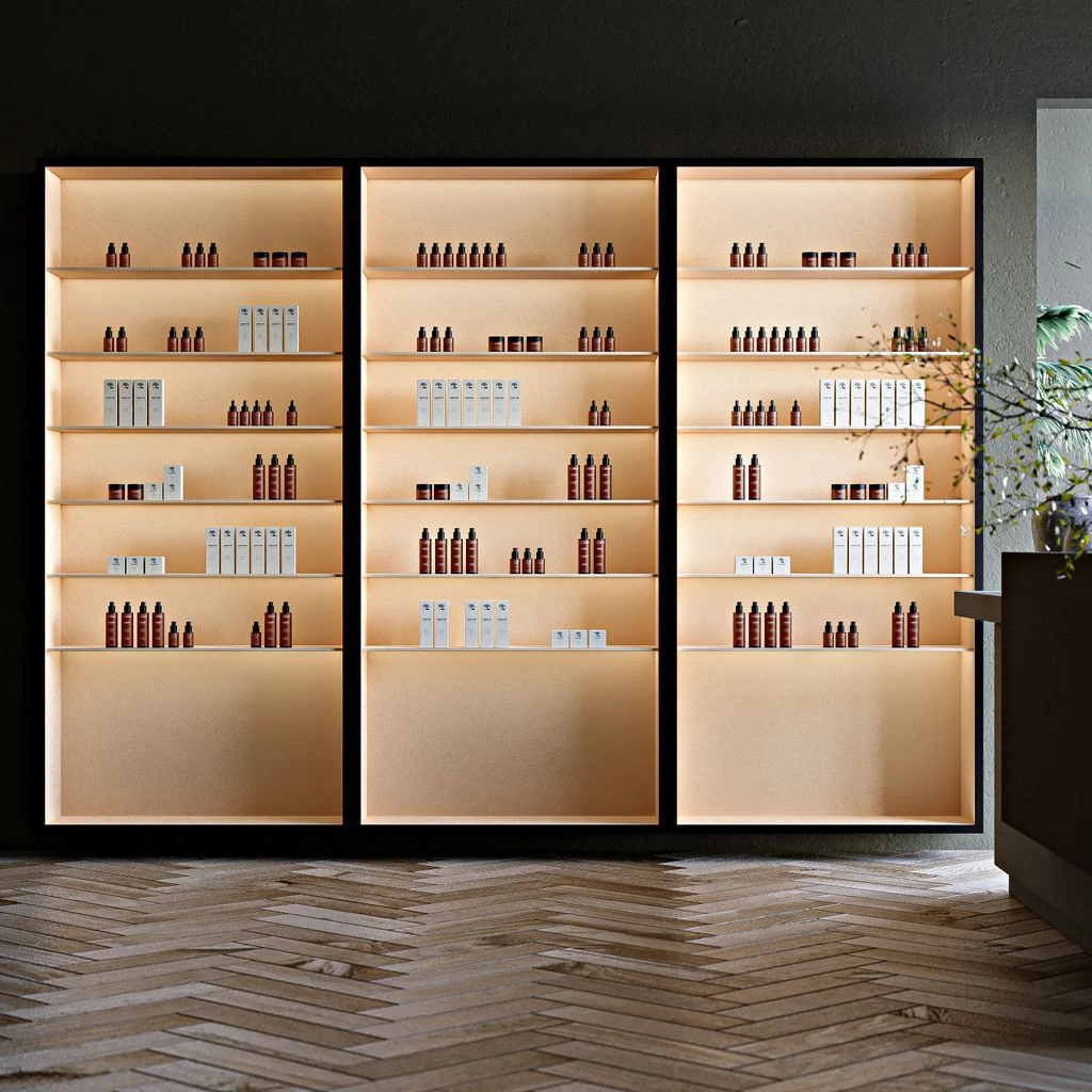 Spa retail display with folded robes, apothecary bottles, and eucalyptus.